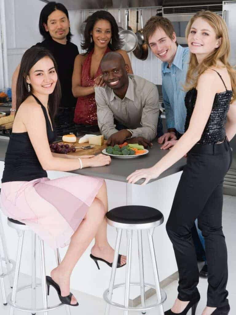 Friends gathered at an island in the kitchen