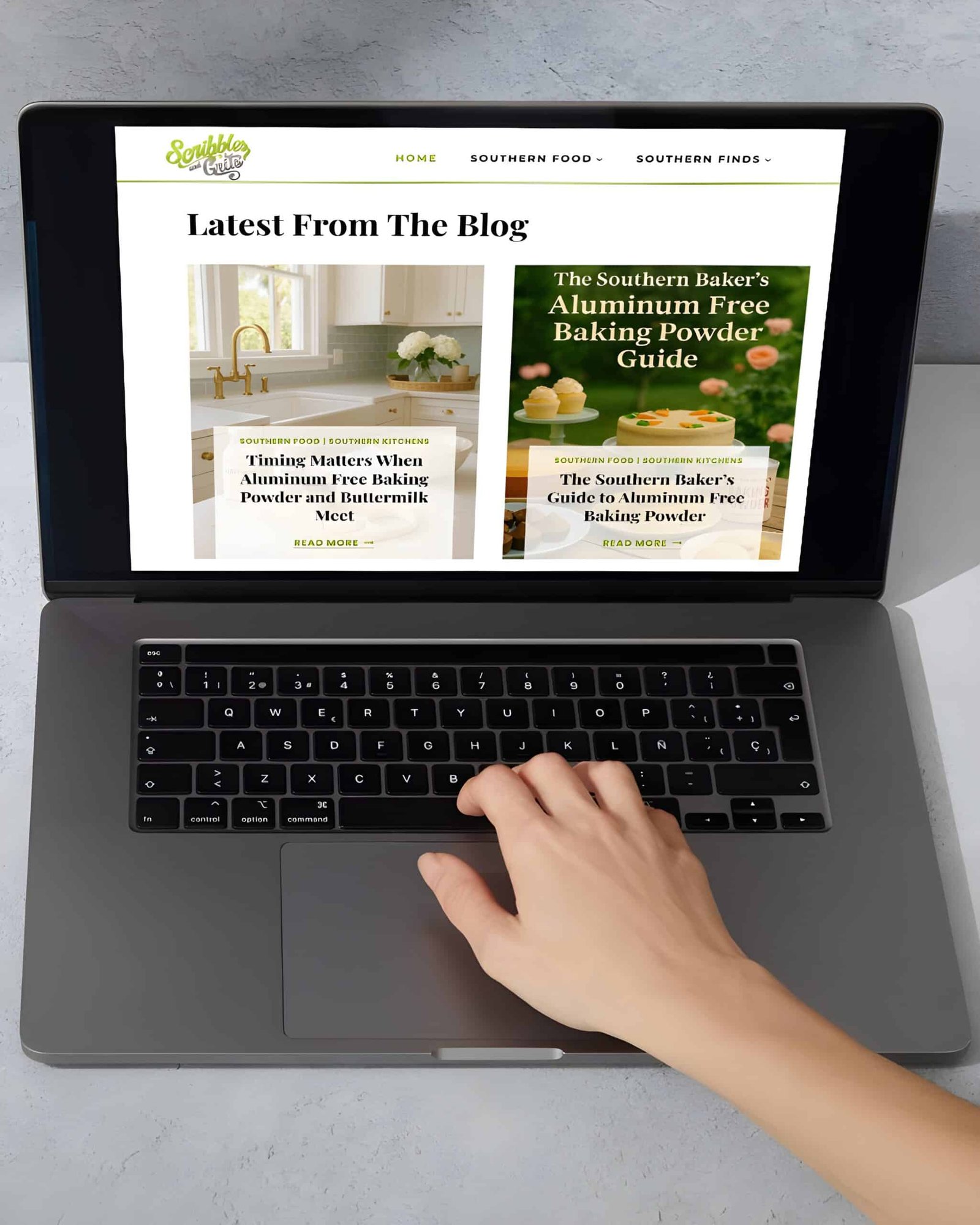 Laptop showing the Scribbles and Grits website and the latest blog posts featuring Aluminum Free Baking Soda vs. Baking Soda 